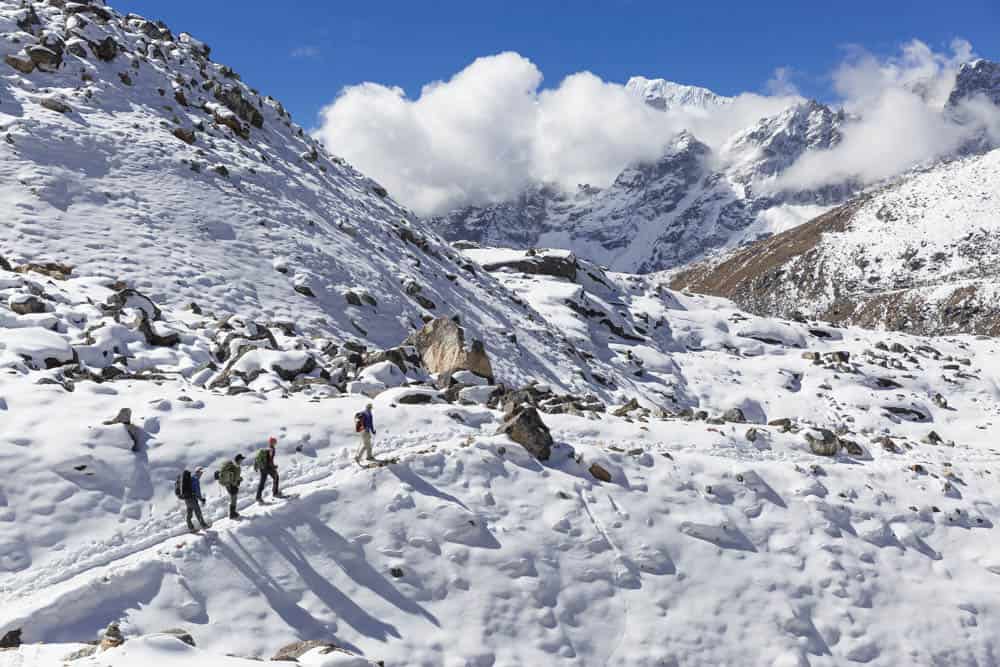 Hikers climbing the renjo la pass everest region, Everest three pass trek